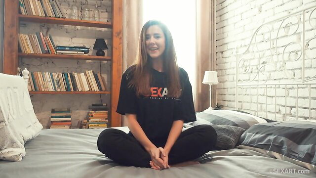 Sybil in MetArt behind-the-scenes interview, sitting sexy on bed