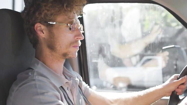 Michael Vegas driving in car, curly haired guy in glasses