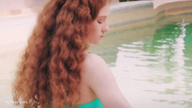 Sofilie redhead in green bikini by pool, wet POV tease