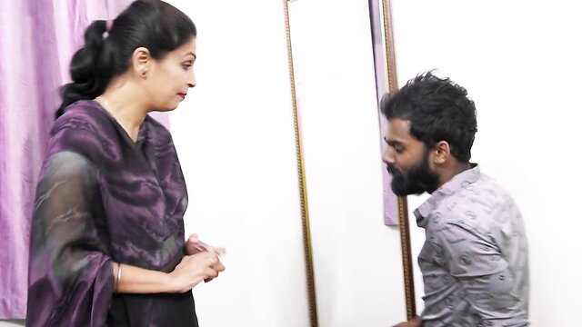 Desi stepmom in sheer purple saree stands over kneeling guy fondling her