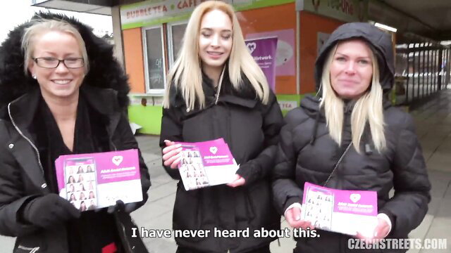 3 blonde Czech beauties handing out pink handjob app flyers on snowy streets