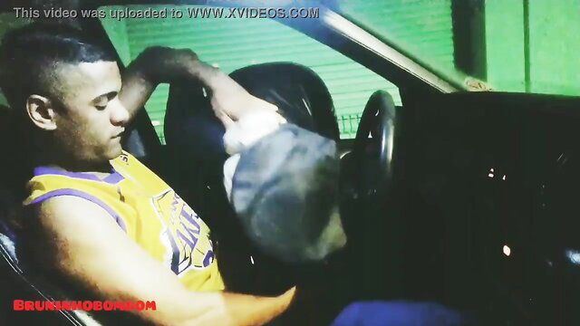 Black guy in Lakers tank top masturbating in car, police hat nearby