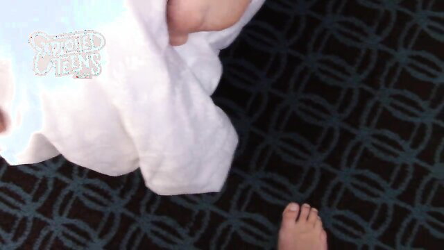 Skinny blonde teen holds white shirt, bare foot visible