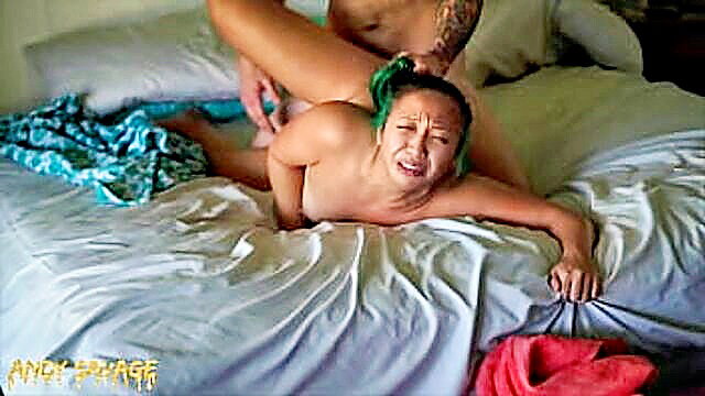 Asian woman crying in intense missionary sex with muscular tattooed white man