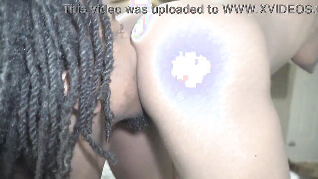 Black man with dreads shows glowing pixelated tattoo on hip in amateur clip