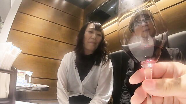 Japanese MILF in 40s holds wine glass in intimate dinner date POV