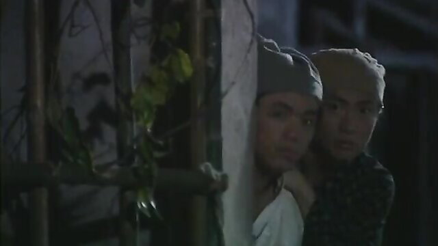 Korean couple peeking through bars in tense nighttime scene