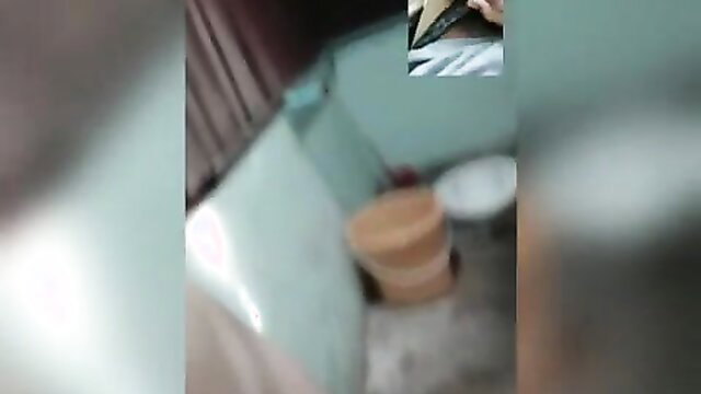 Blurry amateur video of old Asian lady in bathroom with basket