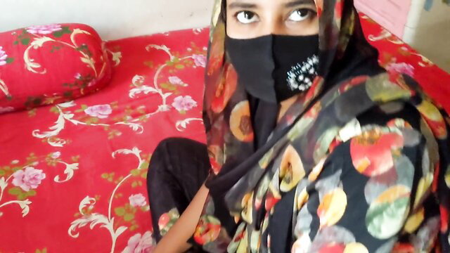 Naughty veiled housewife Shali sits teasingly on bed in hijab