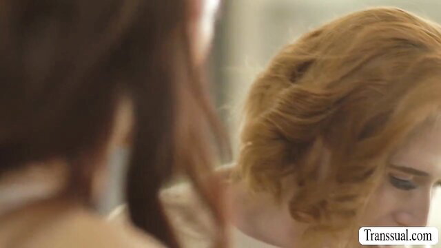 Hot redhead shemale in lingerie kissed by busty TS neighbor