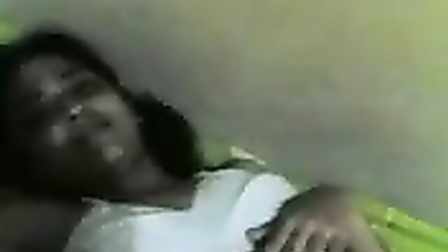 Black babe in white tank top lying back, eyes closed in ecstasy