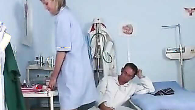 Blonde nurse in uniform checks on male patient in hospital bed