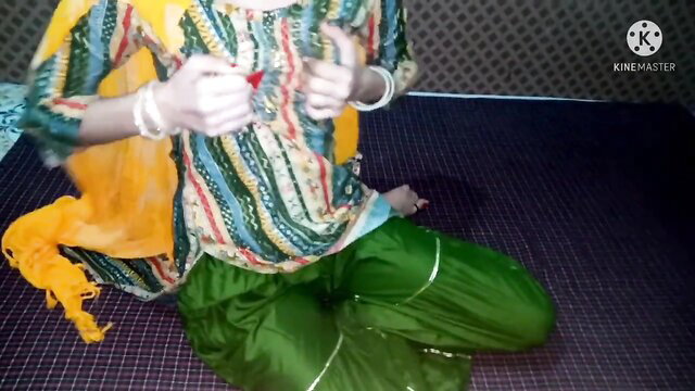 Desi aunty in salwar kameez sitting with hands near crotch, pink pussy tease