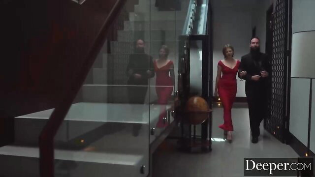 Avery Cristy in tight red dress walks with man in luxury hall