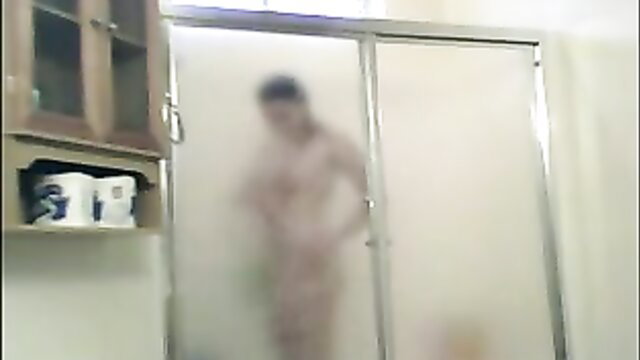 Blurry Asian girl strips nude for hot steamy shower in bathroom