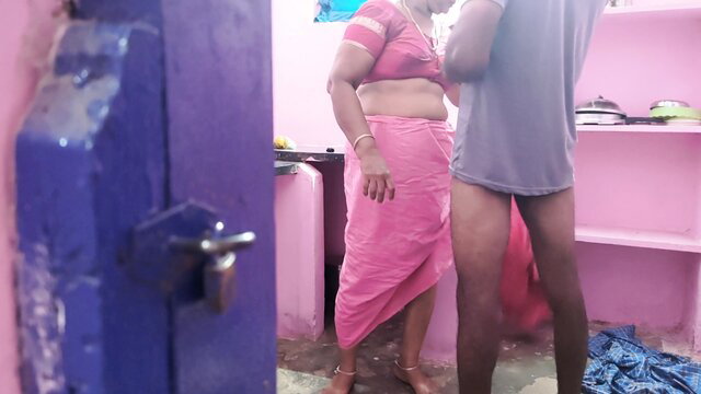 Indian aunty in saree stands nude with man in kitchen