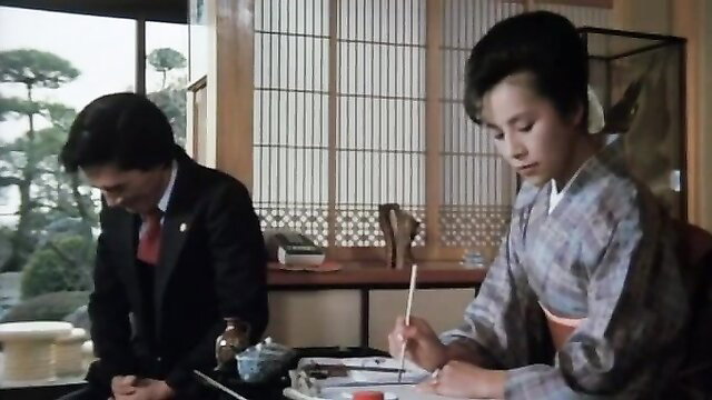 Japanese woman in kimono with suited man at table, classic JAV tease