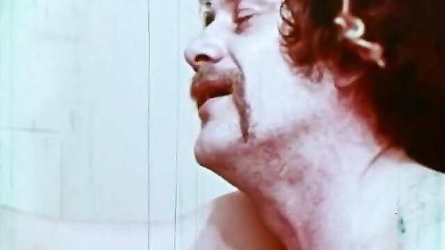 Sensual pale brunette with mustache in steamy bathtub closeup