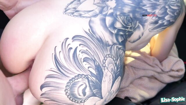 Lisa Sophie tattooed blonde babe's massive tits and back ink closeup