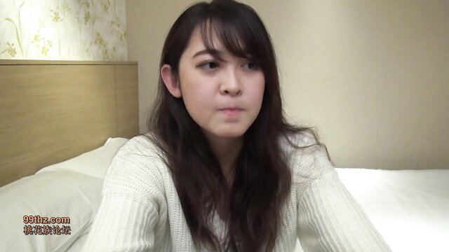 Cute Japanese JAV girl in white sweater on bed, softcore tease