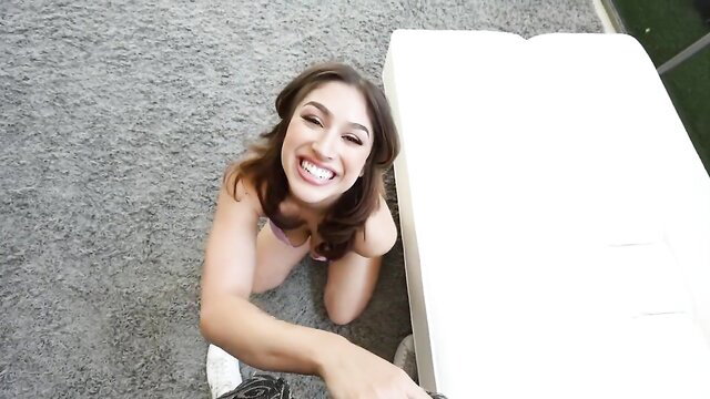 Alexa kneels smiling with massive tits out, hand reaching POV