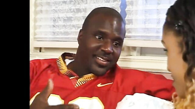 Kenya Chocolate smiles with black man in red Chiefs jersey, steamy threesome tease