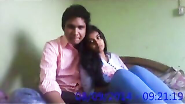 Indian teen couple cuddling intimately on bed