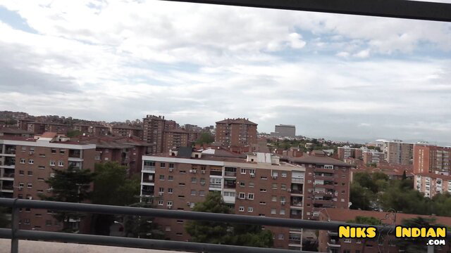 Urban skyline view from apartment balcony with NIKs Indian watermark