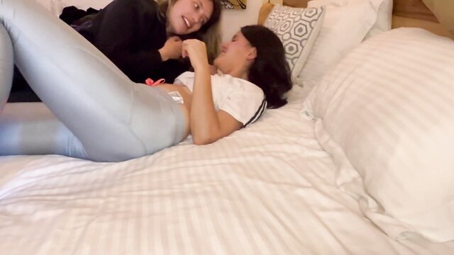 Scarlett and Chanel lesbian play on bed in shiny leggings