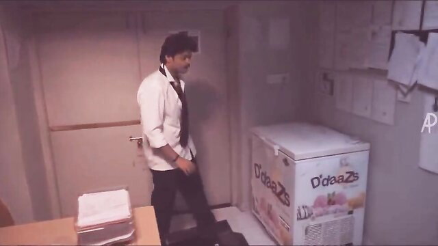 Tamil man in white shirt tie stands by Daaz fridge in wild sex party