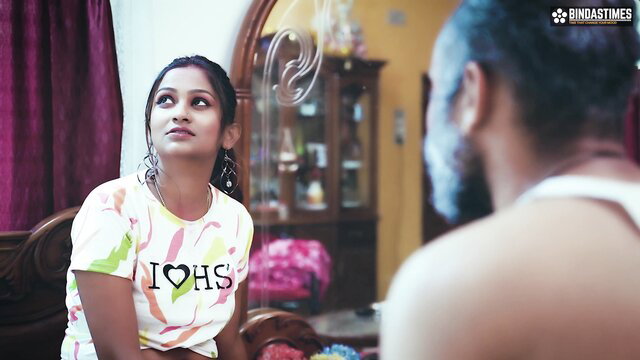Indian beauty in tight printed top looks up seductively at bearded man