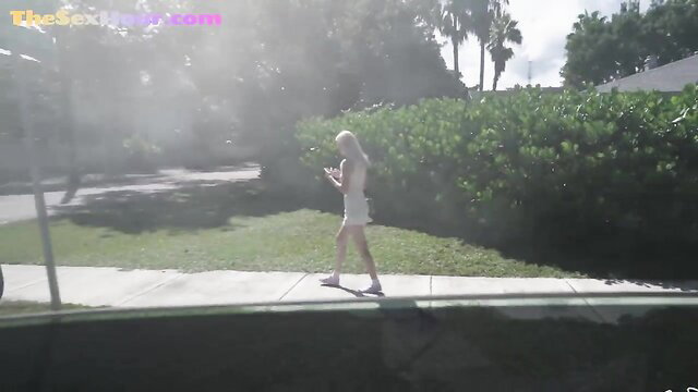 Blonde teen babe in shorts walks by street, ready for kinky bus pickup