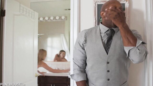 Blonde petite in tub with white guy, suited black man watches outside