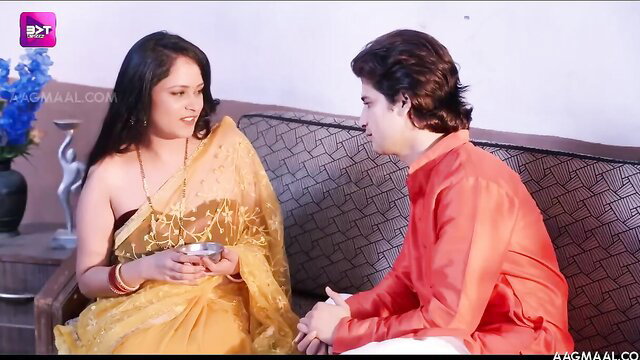 Indian wife in sheer yellow saree flirts with husband on couch