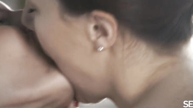 Charli Red licks Tina Tiny's neck in steamy lesbian kiss