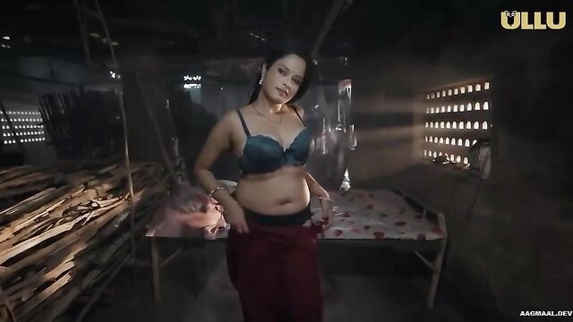 Indian busty woman in blue bra and red skirt posing seductively