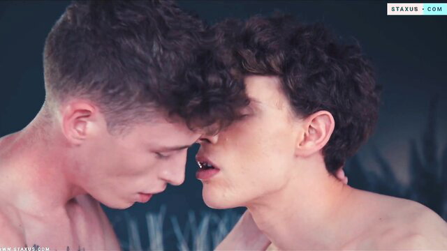 Two hot British twinks nose-to-nose, nude bodies pressed close in steamy threesome tease