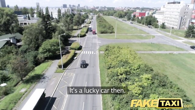 Fake Taxi aerial view of lucky car on sunny urban road