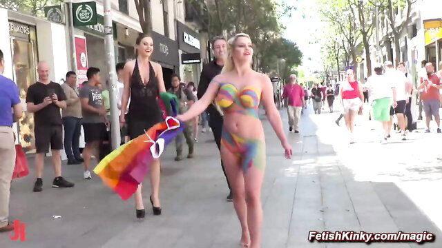 Tina Kay body painted in bikini at pride, Sienna Day in lingerie holds rainbow flag