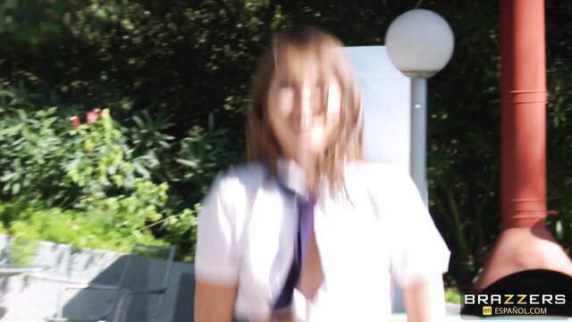 Riley Reid in schoolgirl outfit outdoors, teasing curves