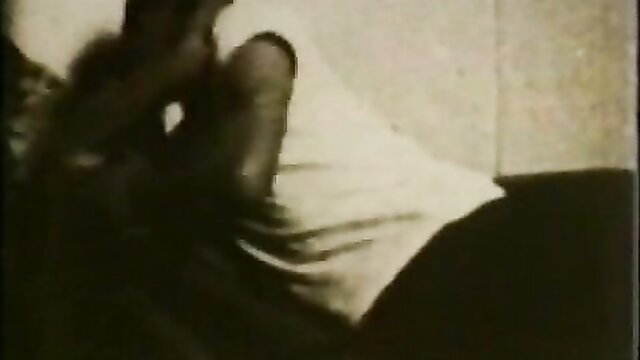 Linda Roberts vintage PAWG in white top, curvy legs spread on bed