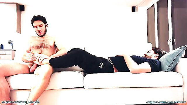 Hairy guy massages friend's feet while stroking his cock and ass