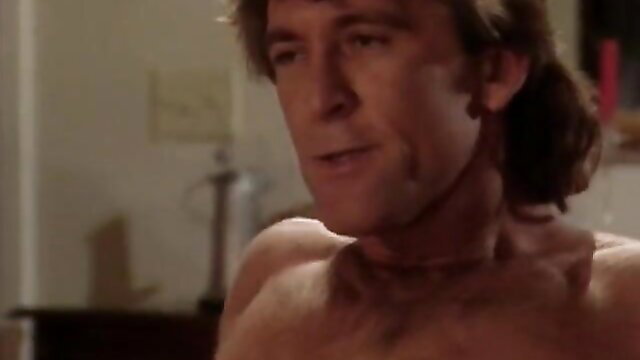 Vintage hunk with ponytail bares ripped torso in steamy hotwife scene