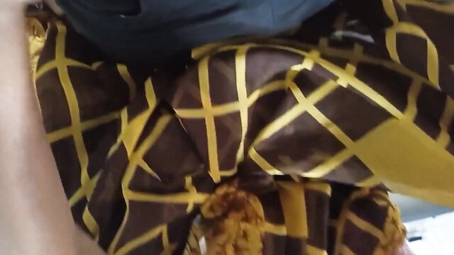 Indian woman in yellow plaid saree, closeup of thighs and hips