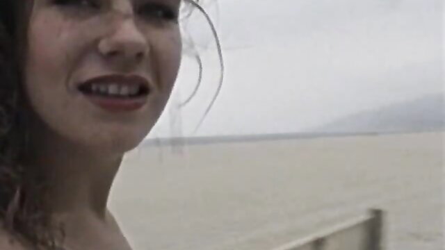 Curly-haired babe teases with glamorous smile by the lake in Evil Angel XXX