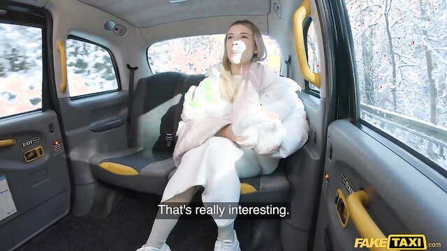 Hot blonde in taxi with bubblegum, white dress and fur coat