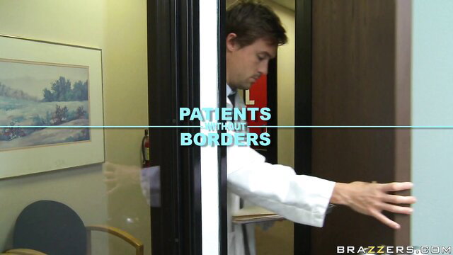 Katie Kox in white doctor coat reaching out in hospital exam