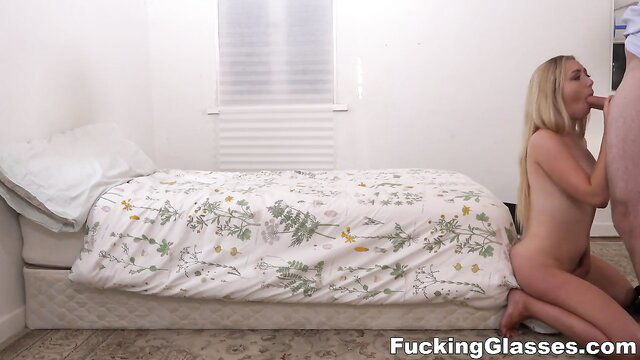 Blonde babe with big tits kneels naked, passionately sucking thick cock