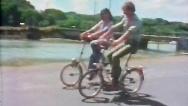 Vintage couple biking outdoors in 70s style