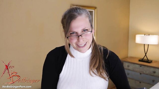Xev Bellringer smiling in tight white turtleneck, big tits bulging